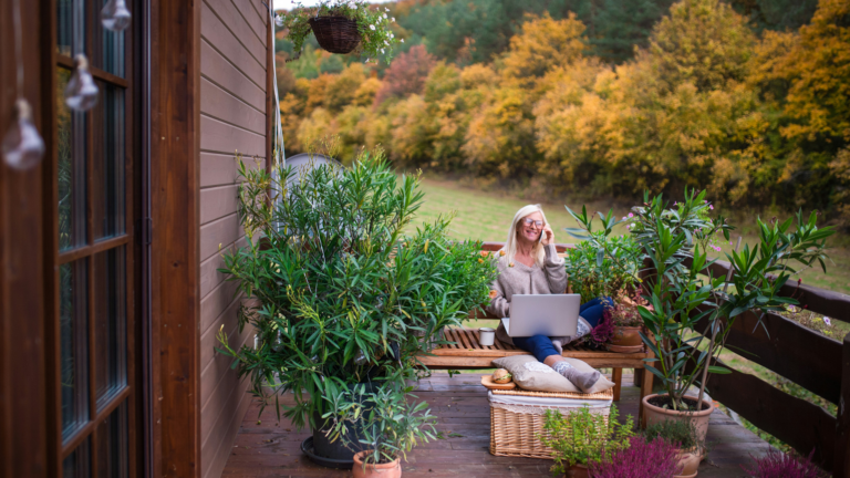 Woman working outside on her terrace.