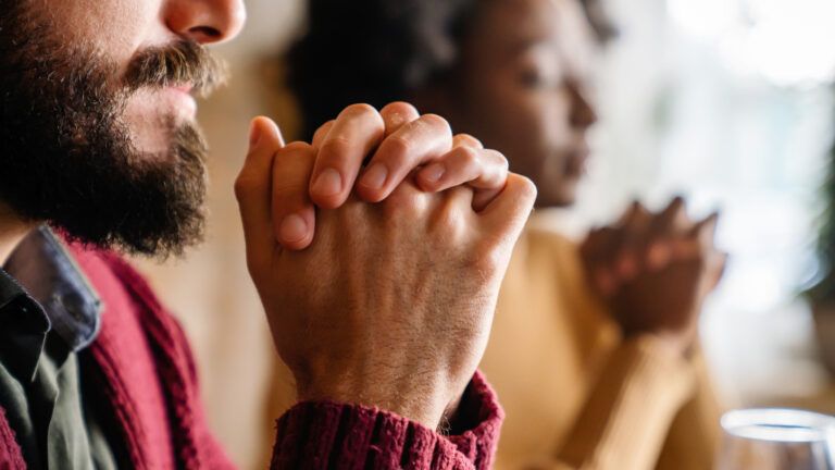Couple praying together to strengthen the faith in their marriage