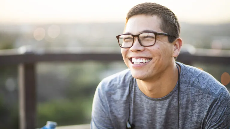 Man smiling outside for his new years habit