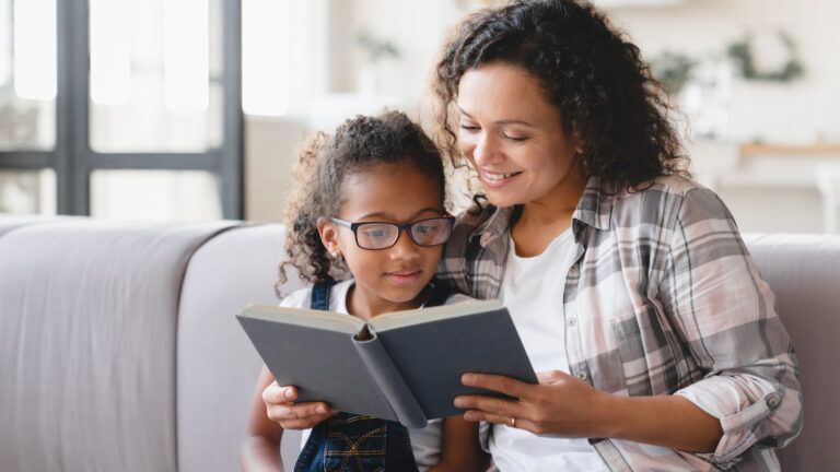 Mom reading to her child. Healthy habits to teach your kids.