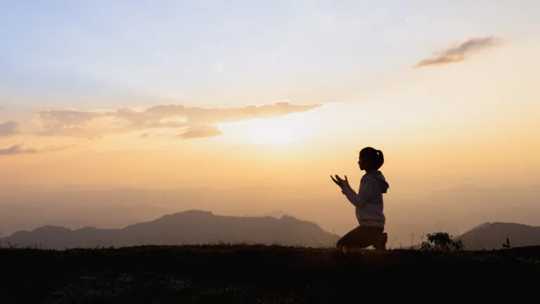 Silhouette of a woman praying the St. Ephrem prayer for Lent outside