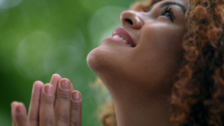 Woman looking up and praying effectively