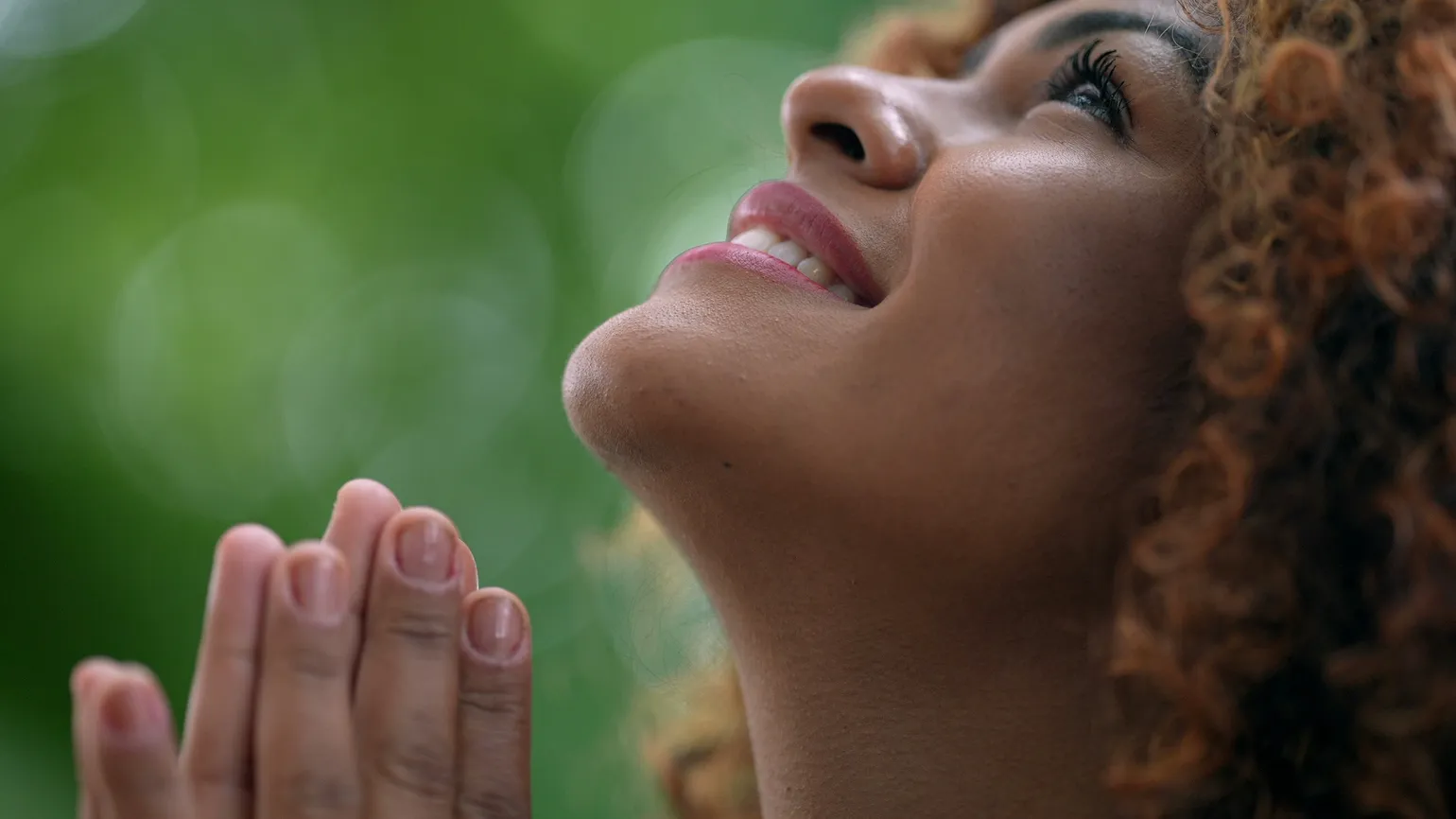 Woman looking up and praying effectively