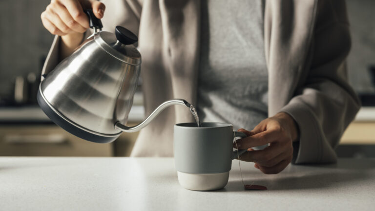 Woman makes tea in the morning as her new years habit