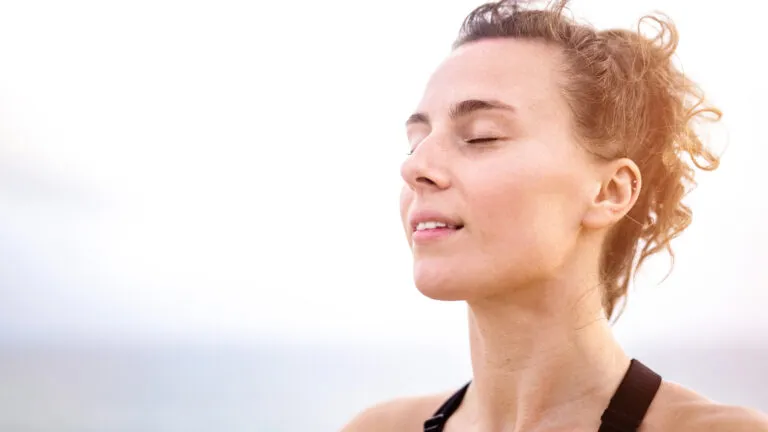 Woman with her eyes closed thinking about the meaning of lent