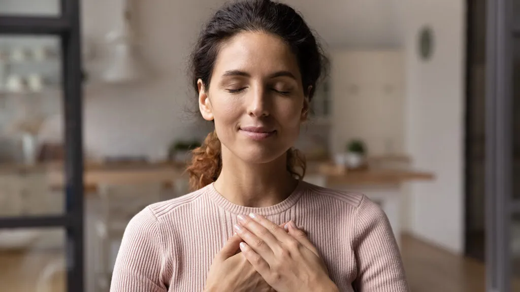 Young woman praying during Lenten season; Getty Images