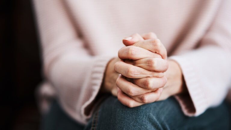 Woman's praying hands during Lent; Getty Images