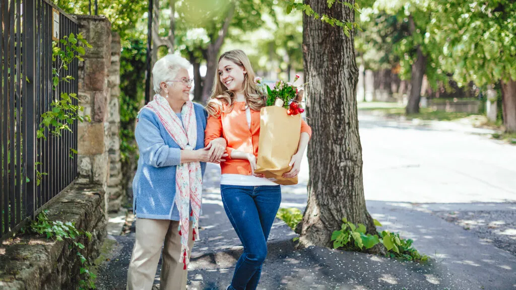 Young woman helping senior woman during Lenten season; Getty Images