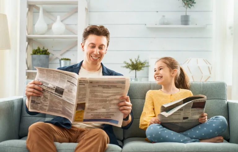 Father and daughter reading up on climate change.