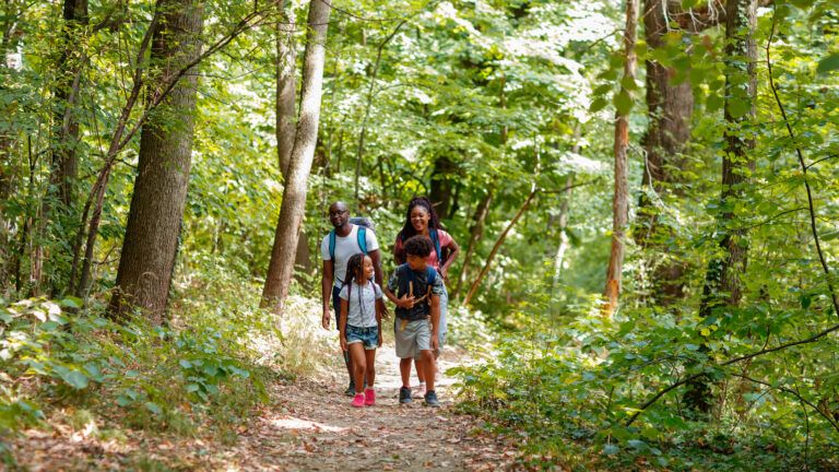Family hiking outdoors. Help your kids help the environment.