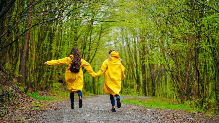 Friends skipping in the rain