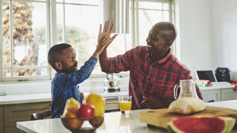 Father and son giving a high five after deciding what to give up for their family lent activities