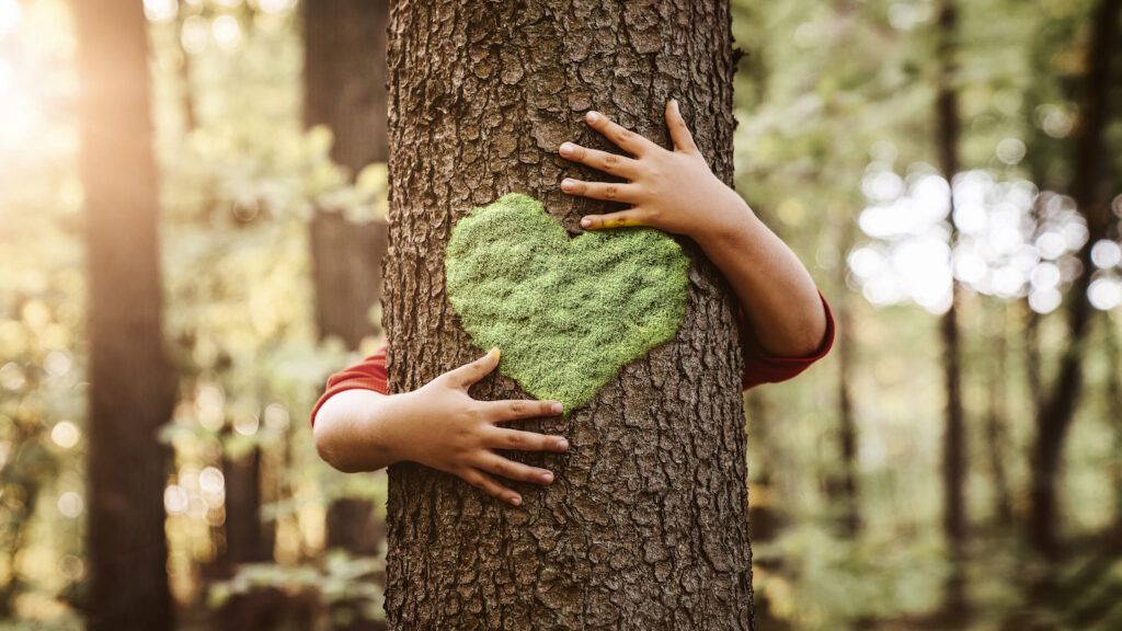 Kid helping the environment while hugging a tree