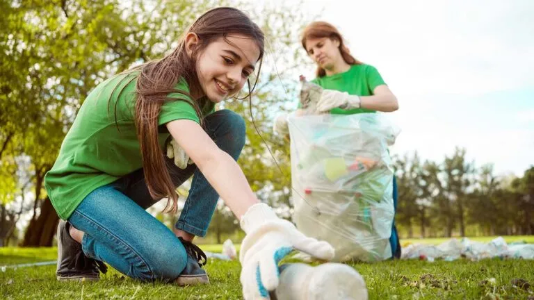 Mother and daughter collecting litter at the park for their family lent activity