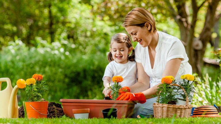 Mother and daughter gardening together to practice a green Lent