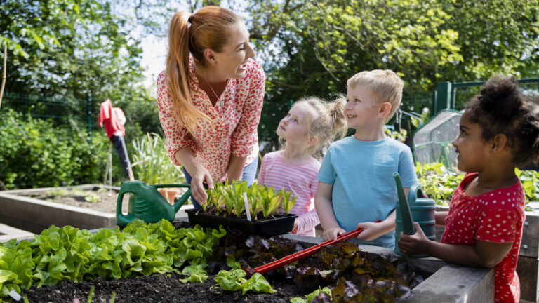 Woman and children preparing a garden