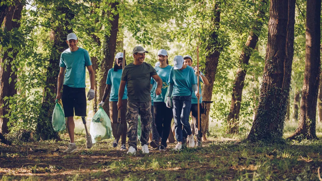 A group of young people volunteering at a local park for their spring activities