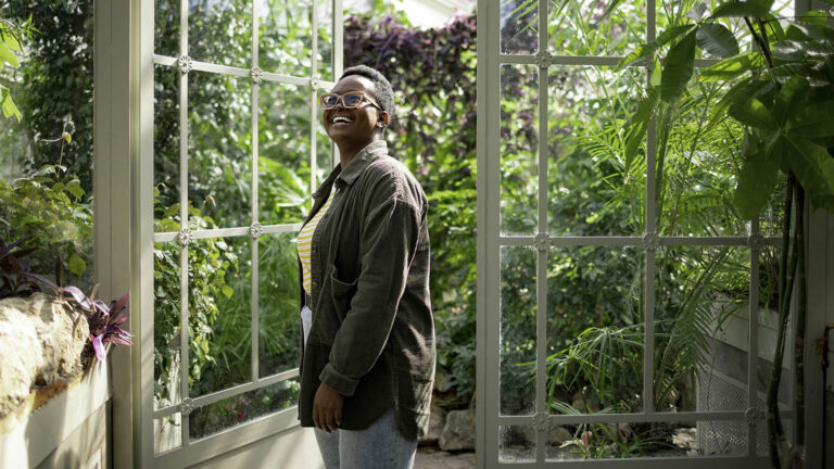 Woman doing the spring activity of visiting a green house in a botanical garden