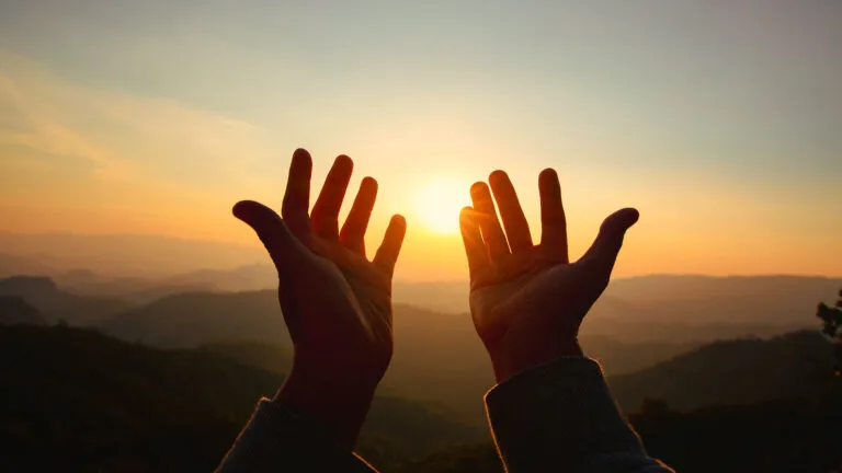 Hands outstretched in prayer