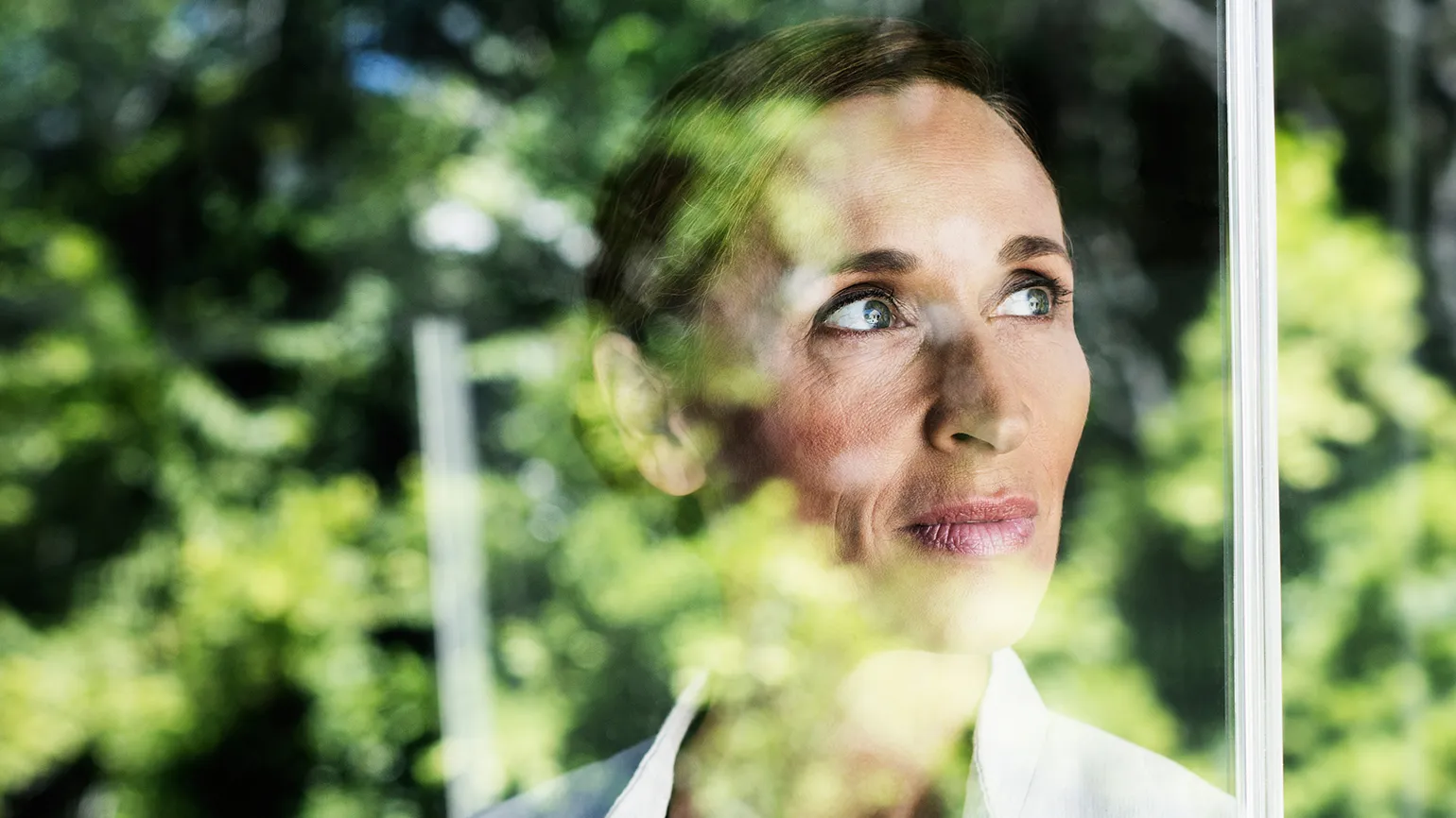 A patient woman gazes out a window